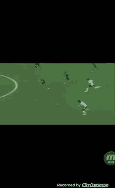 a soccer game is being recorded on a cell phone .