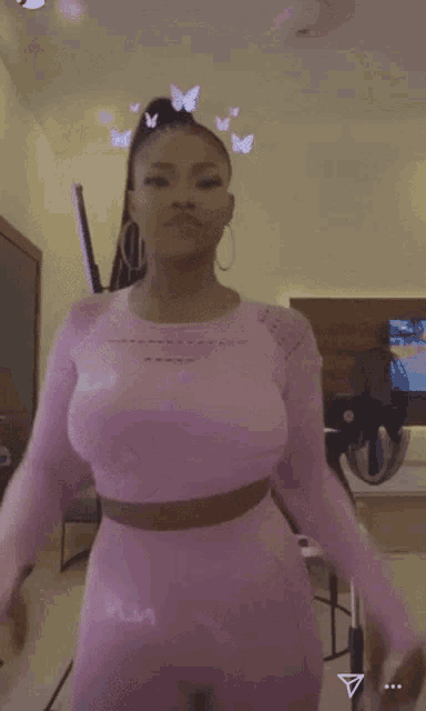 a woman in a pink crop top and leggings is dancing