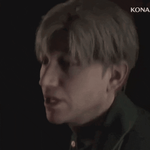 a close up of a man 's face with a kona logo in the corner