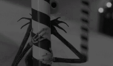 jack skellington from the nightmare before christmas is holding a candy cane .