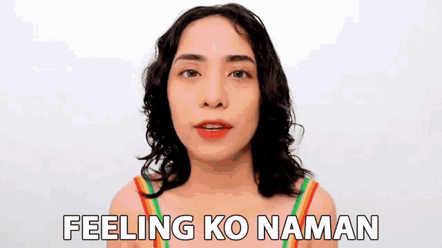 a woman in a rainbow top is saying " feeling ko naman "
