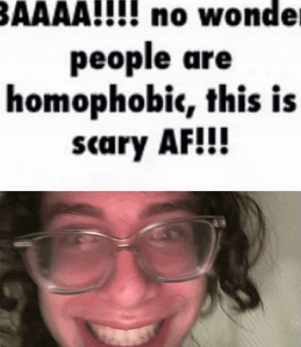 a man wearing glasses is smiling with a caption that says no wonder people are homophobic , this is scary af