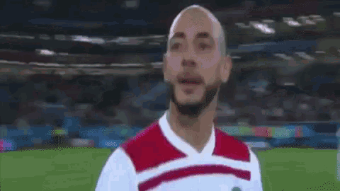 a man in a soccer jersey is giving a thumbs up