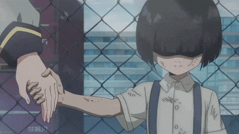a person holding a child 's hand behind a fence
