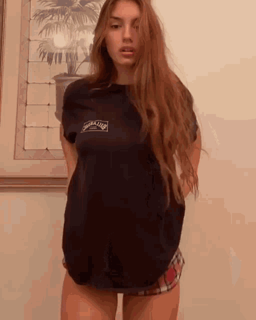 a woman wearing a black t-shirt that says ' moralized ' on it