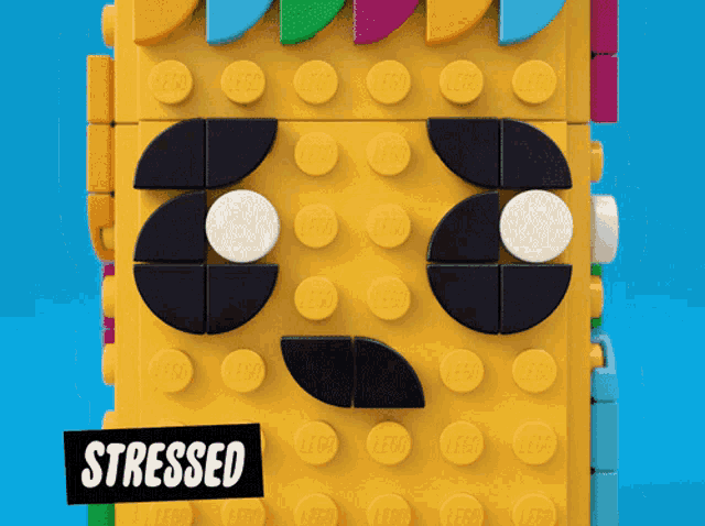 a lego face with a sticker that says " stressed "