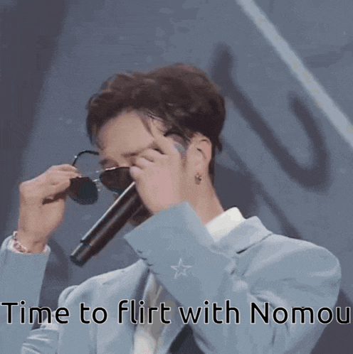 a man covering his eyes with sunglasses and a microphone with the words time to flirt with nomou