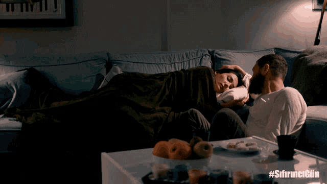 a man and a woman are laying on a couch with the hashtag #sfirncergun on the bottom
