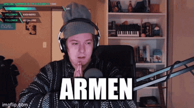 a man wearing headphones prays in front of a microphone with armen written on the screen behind him