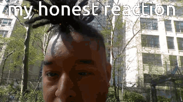 a man with dreadlocks on his head has the words my honest reaction above his head