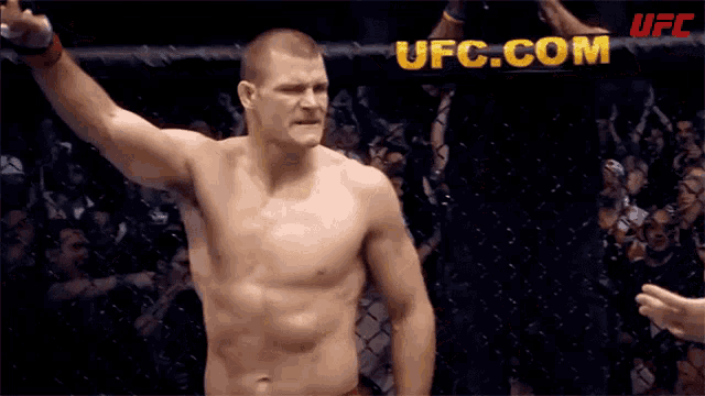 a man in a boxing ring with ufc.com on the bottom