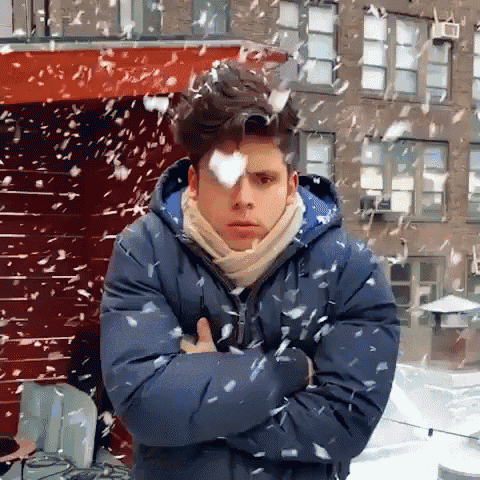 a man with his arms crossed in the snow
