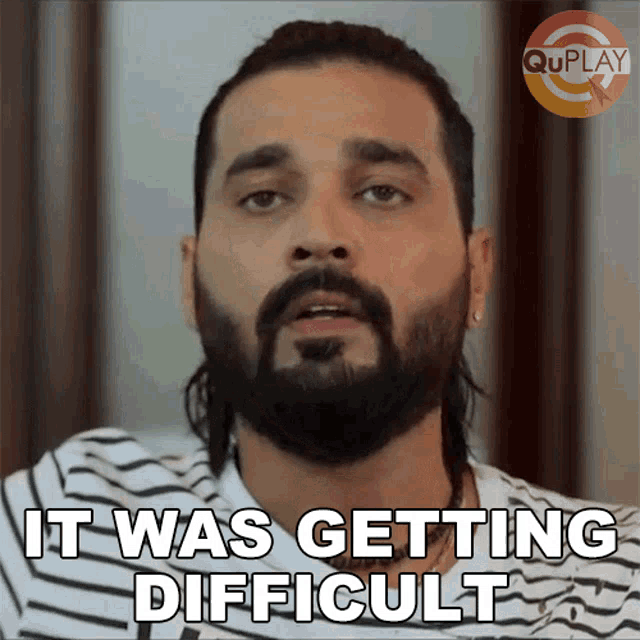 a man with a beard says it was getting difficult in a striped shirt
