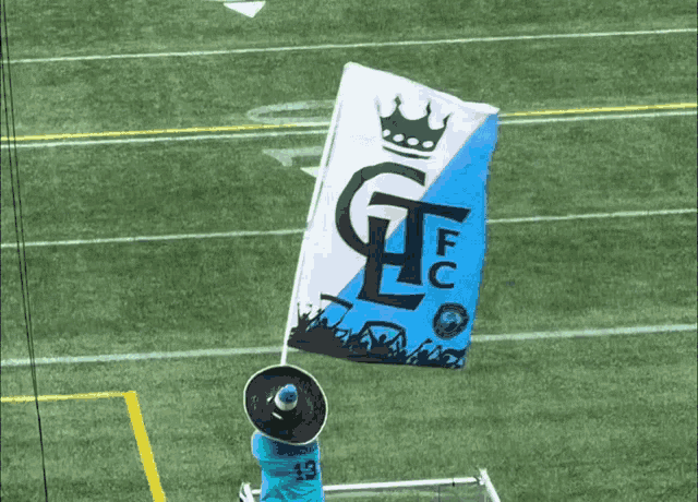a man in a sombrero holds up a flag that says fc