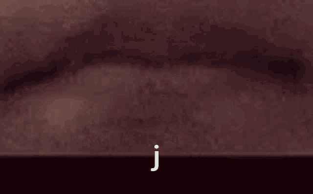 the letter j is on a dark background