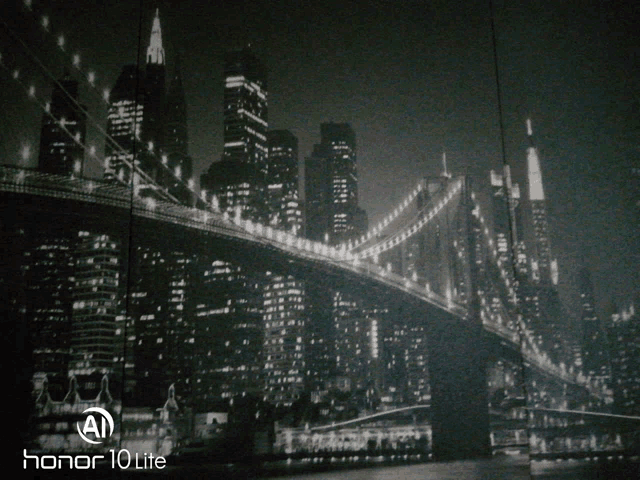 a black and white photo of a bridge with the honor 10 lite logo on the bottom