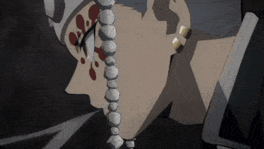 a close up of a person 's face with a string of beads around their neck