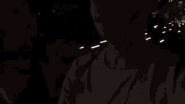 a group of people are walking down a dark street