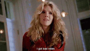 a woman with blonde hair is standing in a room and says `` i got bad vibes '' .