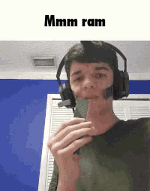 a young man wearing headphones and a headset is eating a green candy bar