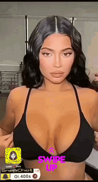 a woman in a black bikini with the words swipe up on the bottom of the screen
