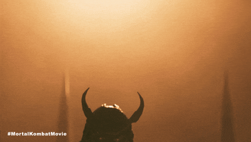 a poster for the mortal kombat movie with a silhouette of a samurai with horns