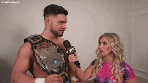 a woman is holding a microphone that says nxt