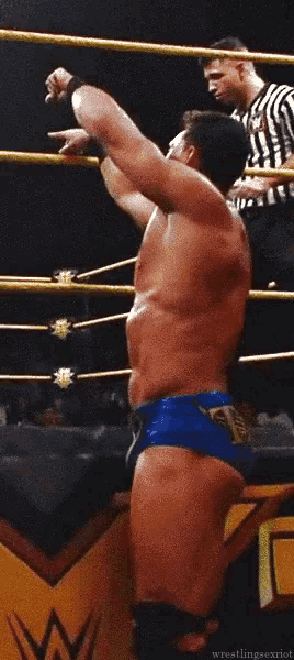 a man in a wrestling ring with the word wrestling on the bottom right