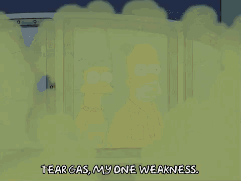 a cartoon of a man with the words tear gas my one weakness on the bottom