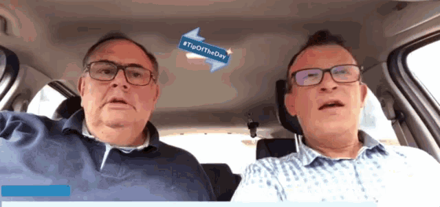 two men are sitting in a car with a sticker that says #tpottheday