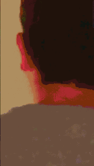 a close up of a person 's neck with a red spot on it