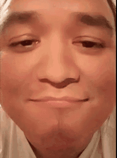 a close up of a man 's face with his eyes closed and his mouth open .