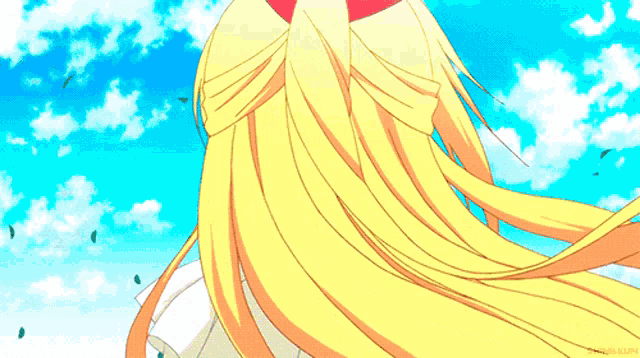 a girl with long blonde hair and blue eyes is wearing a red hat and smiling