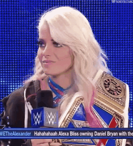 a woman is holding a wrestling championship belt and talking into a microphone on a television show .