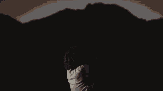 a naked woman holds a white cloth over her head