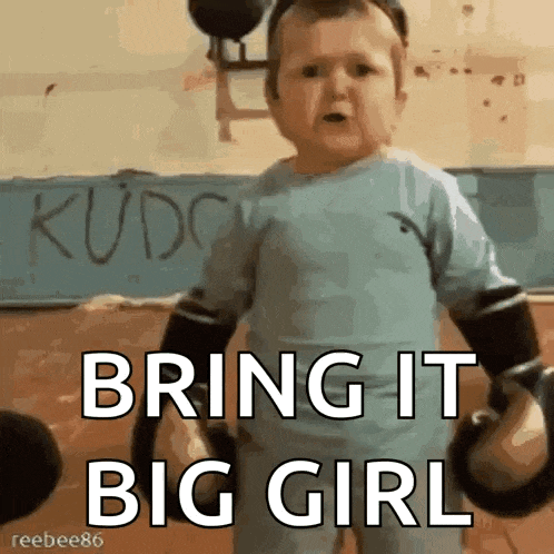 a baby is wearing boxing gloves and saying " bring it big girl "