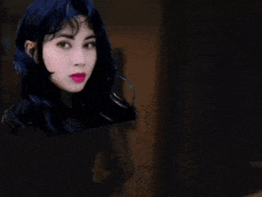 a close up of a woman 's face with a blue wig