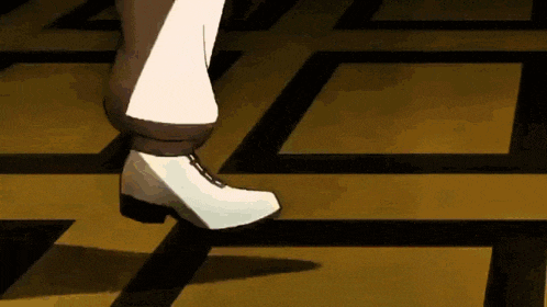 a person wearing white shoes is walking on a tiled floor .