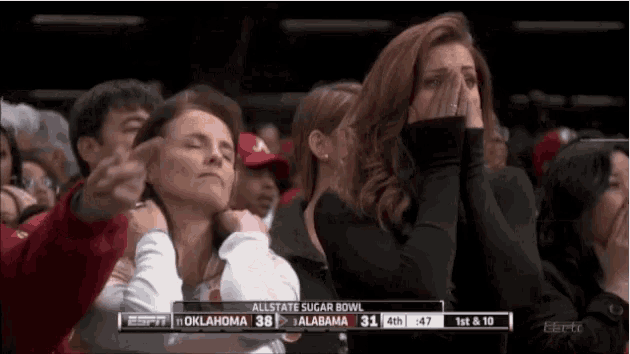 a group of people are watching a game between oklahoma and alabama on espn