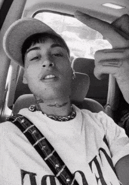 a man with a tattoo on his neck is wearing a white t-shirt that says ' i love you ' on it