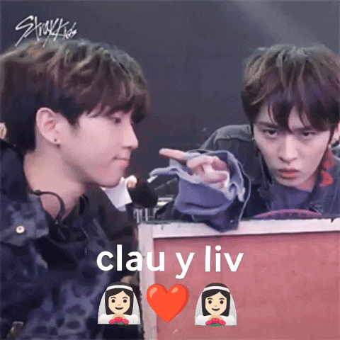 a couple of boys are looking at each other with the words clau y liv on the bottom