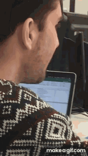 a man wearing a sweater that says ' make a gif ' on it