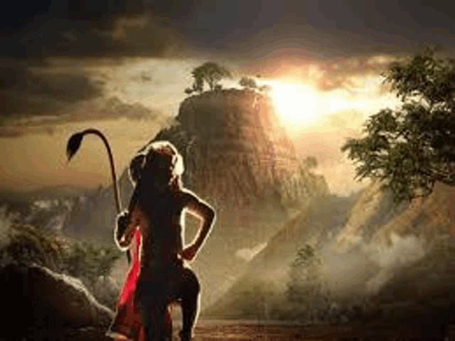 a monkey with a long tail is standing in front of a mountain holding a spear .