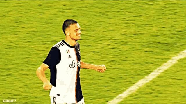 a man wearing a jeep jersey stands on a field