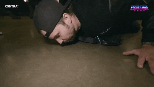 a man is crawling on the floor with contra written on the bottom