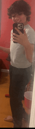 a young boy is taking a selfie in front of a mirror