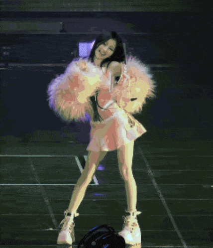 a pixelated image of a woman dancing on a stage with a blue background