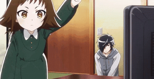 a little girl is standing in front of a television while a man kneeling down looks on .