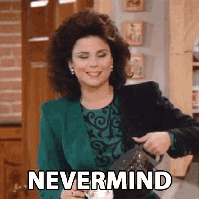 a woman in a green jacket is smiling and holding a cup with the word nevermind written on it .