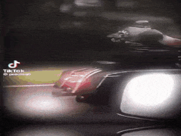 a tiktok video of a person riding a motorcycle at night .